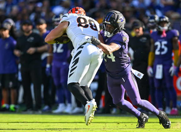 Baltimore Ravens safety Malaki Starks (24) brings down Cincinnati Bengals tight end Drew Sample (89) after a pass reception during the fourth quarter at M&T Bank Stadium in Baltimore, Maryland, on Sunday, October 25, 2026. Cincinnati won 35-13.  BAL20261025124 DAVIDxTULIS
