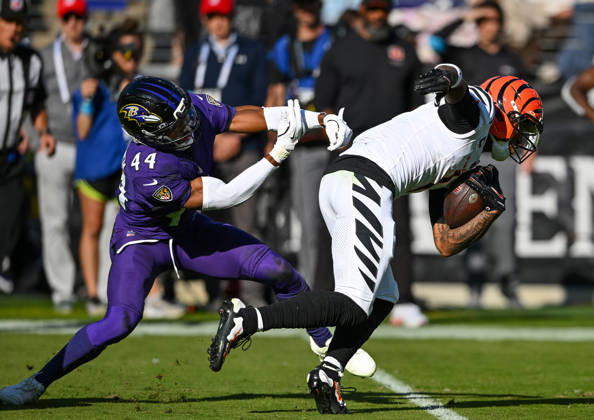 Cincinnati Bengals wide receiver Ja marr Chase (1) escapes an attempted tackle by Baltimore Ravens cornerback Marlon Humphrey (44) on a 30 yard pass play during the fourth quarter at M&T Bank Stadium in Baltimore, Maryland, on Sunday, October 25, 2026. Cincinnati won 35-13.  BAL20261025113 DAVIDxTULIS