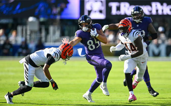 Baltimore Ravens tight end Josh Cuevas (85) pushes away Cincinnati Bengals safety Bryan Cook (6) and linebacker Demetrius Knight Jr. (44) on a first down run during the third quarter at M&T Bank Stadium in Baltimore, Maryland, on Sunday, October 25, 2026. Cincinnati won 35-13.  BAL20261025123 DAVIDxTULIS