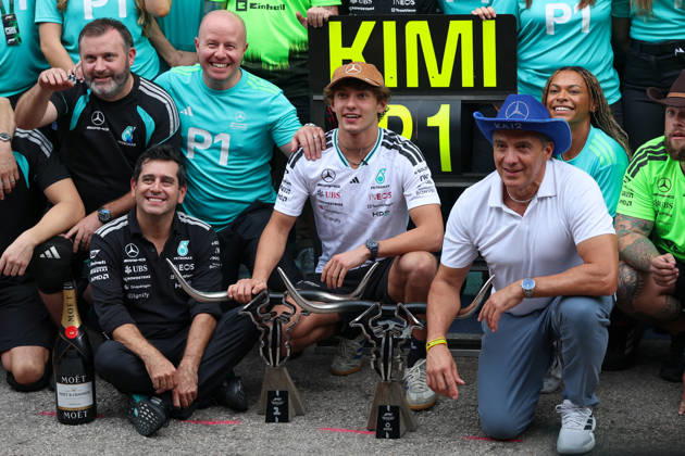 AUSTIN, TX - OCTOBER 25: Andrea Kimi Antonelli (12) of Italy and Mercedes-AMG PETRONAS Formula One Team kneels with his championship trophy as his dad Marco Antonelli sits by his side after winning the Formula 1 MSC Cruises United States Grand Prix on October 25, 2026, at Circuit of The Americas in Austin, Texas.(Photo by David Buono Icon Sportswire) AUTO: OCT 25 F1 United States Grand Prix EDITORIAL USE ONLY Icon2610250811