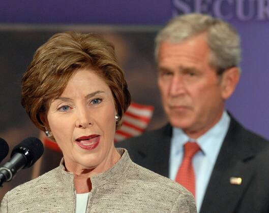 First Lady Laura Bush dahinter Ehemann Präsident George W. Bush (beide USA) während ihrer Rede vor dem U.S. Global Leadership Campaign in Washington D.C. -  (wap2007053104)