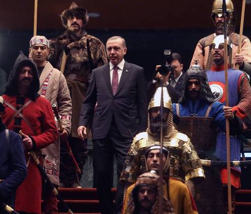 Turkish President Recep Tayyip Erdogan in front of 16 soldiers who represent the 16 Turkish states founded in the past at the presidential palace in Ankara, Turkey on January 12, 2015