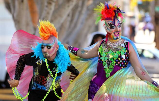 October 8, 2016 - Oceanside, California, USA - 10 8 2016 Oceanside, CA_EARTH INTRUDER, left, and GLAM GLITZ, at right, make their way down Pier View Way in downtown Oceanside, California at the annual North County Pride at the Beach festival. The event was sponsored by the North County LGBTQ Resource Center. They were the event s MC s._Photo by Oceanside USA - ZUMAn47_