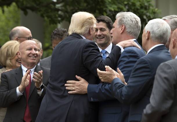 President Donald Trump embraces Speaker of the House Paul Ryan, R-Wis. (L) and House Majority Leader Kevin McCarthy, R-Calif., during a press event celebrating the House passage of Republican legislation to roll back the Affordable Care Act, at the White House in Washington, D.C. on May 4, 2017. The American Health Care Act passed the House with a vote of 217-213 vote. It will next move to the Senate.  WAP20170504331 KEVINxDIETSCH