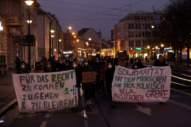 Protesters walk with banners in Friedrich Ebert street during a sea bridge demonstration for the reception of refugees from the Polish-Belarusian border area, Potsdam, 18 December 2021 sea bridge demo in Potsdam