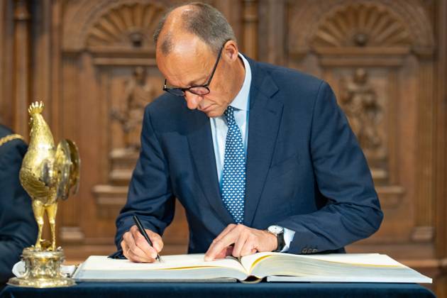 Federal Chancellor Friedrich Merz signs the City of Münsters Golden Book in the Friedenssaal Chancellors inaugural visit to North Rhine-Westphalia Münster , Münster North Rhine-Westphalia Germany City Hall