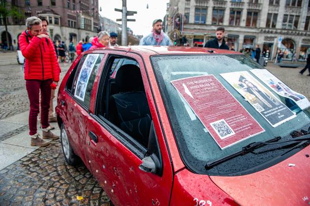 October 5, 2025, Amsterdam, North Holland, Netherlands: A woman in red clothes cries as she inspects a car full of bullets. A vehicle representing five-year-old Hind Rajab and her family, who were killed during an Israeli army attack in the Tel al-Hawa area of Gaza in January 2024, has been exhibited in the Netherlands. Amsterdam Netherlands - ZUMAs197 20251005_aaa_s197_618 Copyright: xAnaxFernandezx