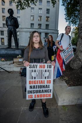 October 6, 2025, London, United Kingdom: A protester holds a placard during the demonstration. A couple of hundred people gathered outside Downing Street to protest against Keir Starmer™s proposal to introduce digital ID into the UK. The demonstration was arranged by Turning Point the organisation originally set up by murdered American far-right activist Charlie Kirk. London United Kingdom - ZUMAs197 20251006_aaa_s197_222 Copyright: xLabxKyxMox