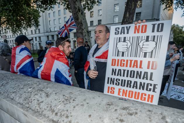 October 6, 2025, London, United Kingdom: A protester holds a placard during the demonstration. A couple of hundred people gathered outside Downing Street to protest against Keir Starmer™s proposal to introduce digital ID into the UK. The demonstration was arranged by Turning Point the organisation originally set up by murdered American far-right activist Charlie Kirk. London United Kingdom - ZUMAs197 20251006_aaa_s197_234 Copyright: xLabxKyxMox