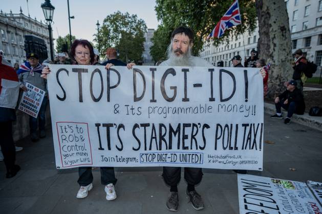 October 6, 2025, London, United Kingdom: Protestors hold a large banner during the demonstration. A couple of hundred people gathered outside Downing Street to protest against Keir Starmer™s proposal to introduce digital ID into the UK. The demonstration was arranged by Turning Point the organisation originally set up by murdered American far-right activist Charlie Kirk. London United Kingdom - ZUMAs197 20251006_aaa_s197_240 Copyright: xLabxKyxMox