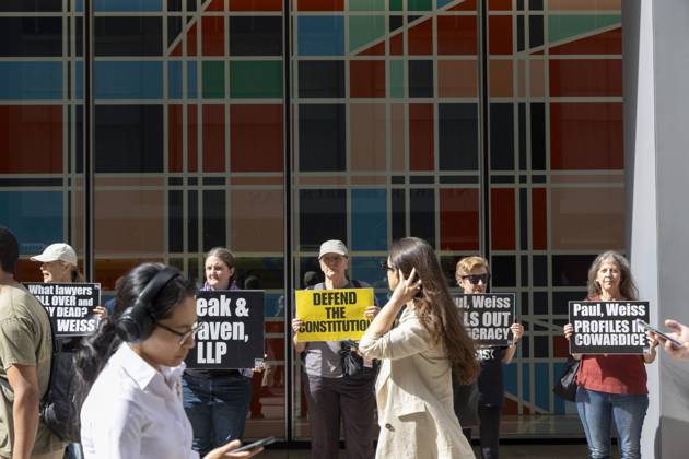 October 7, 2025, New York, New York, USA: Demonstrators with the activist group Rise and Resist hold signs that read DEFEND THE CONSTITUTION Paul, Weiss PROFILES IN COWARDICE outside of the offices of Paul, Weiss, Rifkind, Wharton and Garrison LLP as lunchtime crowds pass in midtown Manhattan. Protesters stage a peaceful demonstration to denounce the law firm s agreement to provide millions in pro bono legal work to initiatives from President Trumpâ€⠢s agenda and to abandon diversity, equity, and inclusion (DEI) policies. New York USA - ZUMAr174 20251007_znp_r174_042 Copyright: xGinaxMxRandazzox