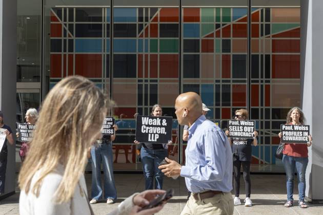 October 7, 2025, New York, New York, USA: Demonstrators with the activist group Rise and Resist hold signs that read Weak and Craven, LLP Paul, Weiss SELLS OUT DEMOCRACY Paul, Weiss PROFILES IN COWARDICE outside of the offices of Paul, Weiss, Rifkind, Wharton and Garrison LLP as lunchtime crowds pass in midtown Manhattan. Protesters stage a peaceful demonstration to denounce the law firm s agreement to provide millions in pro bono legal work to initiatives from President Trumpâ€⠢s agenda and to abandon diversity, equity, and inclusion (DEI) policies. New York USA - ZUMAr174 20251007_znp_r174_045 Copyright: xGinaxMxRandazzox