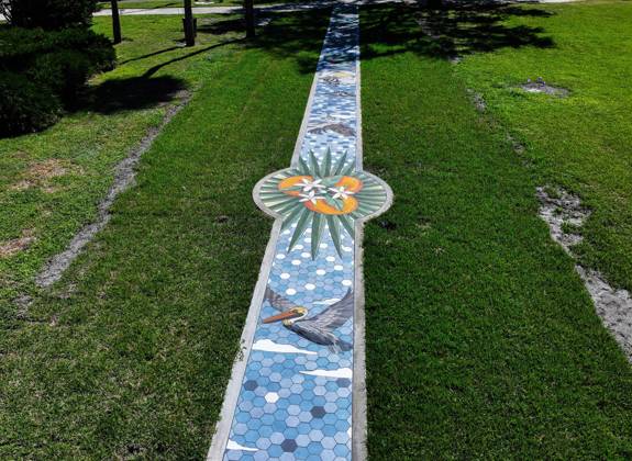 October 13, 2025, St. Petersburg, Florida, USA: An aerial drone view of The Sunshine City Mosaic sidewalk mural at Sunset Park, 7340 Central Ave, on Monday, Oct. 13, 2025 in St. Petersburg. The 175 foot long side walk mural is the largest in the Southeast. St. Petersburg USA - ZUMAidew 20251013_zan_s70_050 Copyright: xDirkxShaddx