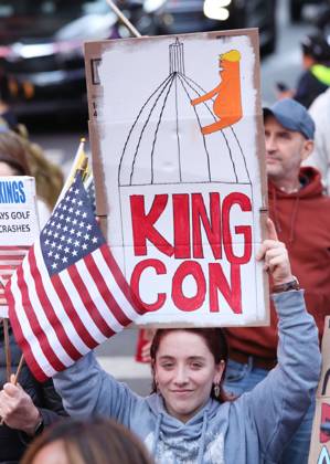 October 18, 2025, New York City, New York, USA: A woman holds a sign that says King Con during the No Kings protest in New York City on Oct. 18, 2025. Tens of thousands of people hit New York City streets to protest Donald Trump, autocracy, ICE and immigrant deportations. More than 2,500 similar protests took place nationwide. New York City USA - ZUMAk45_ 20251018_zaf_k45_018 Copyright: xKristaxKennellx
