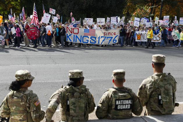 October 18, 2025, Washington Dc, Washington Dc, USA: National Guard members are seen while demonstrators take part in a protest against the Donald Trump administration during the No Kings national rally on October 18, 2025, in Washington, DC, USA. Millions of people across the nation joined the No Kings protest to demonstrate their disapproval of the current US administration. The No Kings Day of Defiance has been organized to reject authoritarianism, billionaire-first politics, and the militarization of the countryÃ¢â‚¬â ¢s democracy, according to a statement by organizers. Washington Dc USA - ZUMAk203 20251018_znp_k203_018 Copyright: xAashishxKiphayetx
