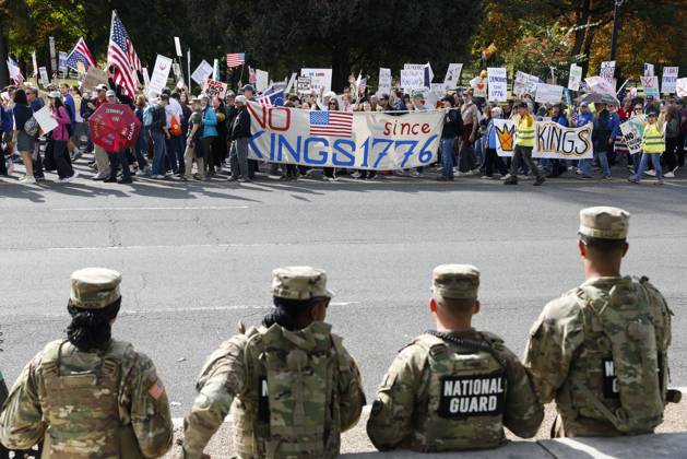 October 18, 2025, Washington Dc, Washington Dc, USA: National Guard members are seen while demonstrators take part in a protest against the Donald Trump administration during the No Kings national rally on October 18, 2025, in Washington, DC, USA. Millions of people across the nation joined the No Kings protest to demonstrate their disapproval of the current US administration. The No Kings Day of Defiance has been organized to reject authoritarianism, billionaire-first politics, and the militarization of the countryÃ¢â‚¬â ¢s democracy, according to a statement by organizers. Washington Dc USA - ZUMAk203 20251018_znp_k203_019 Copyright: xAashishxKiphayetx