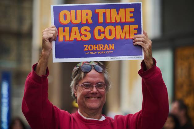 October 18, 2025, New York, New York, USA: Protester holds up a sign that reads, Ã¢â‚¬oeOur Time Has ComeÃ¢â‚¬Â¦Zohran for New York CityÃ¢â‚¬Â in the New York City No Kings protest in opposition to measures Donald Trump has taken to install authoritarian style rule. New York USA - ZUMAl171 20251018_znp_l171_032 Copyright: xEdnaxLeshowitzx