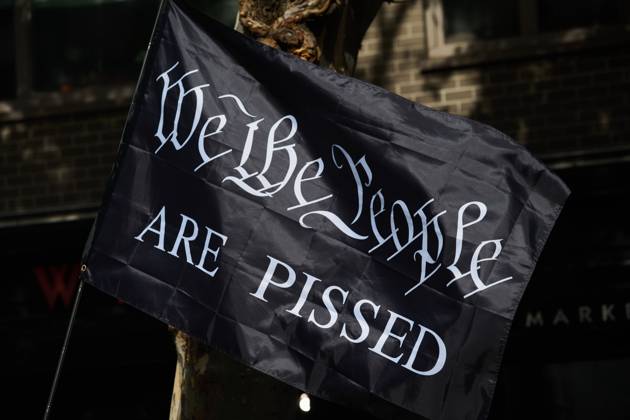 October 18, 2025, New York, New York, USA: Protester holds black flag that reads, Ã¢â‚¬oeWe The People Are PissedÃ¢â‚¬Â in the New York City No Kings protest in opposition to measures Donald Trump has taken to install authoritarian style rule. New York USA - ZUMAl171 20251018_znp_l171_035 Copyright: xEdnaxLeshowitzx