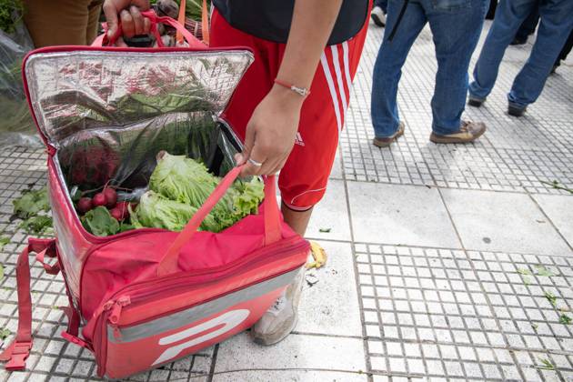 October 16, 2025, Buenos Aires, Buenos Aires, Argentina: A Delivery Worker Packs Food into His Backpack.During the farmersÃ¢â‚¬â ¢ protest at Plaza de Mayo, fresh produce is freely distributed to spotlight the sectorÃ¢â‚¬â ¢s production and consumption crisis. Buenos Aires Argentina - ZUMAp265 20251016_zip_p265_012 Copyright: xDelfinaxCorberaxPix