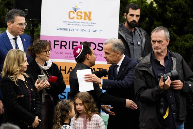 October 21, 2025, Ottawa, On, CAN: Prime Minister Mark Carney is embraced by Shopify president Harley Finkelstein, after making remarks at the opening of the Finkelstein Chabad Jewish Centre in Ottawa, on Tuesday, Oct. 21, 2025. Ottawa CAN - ZUMAc35_ 20251021_zaf_c35_184 Copyright: xJustinxTangx