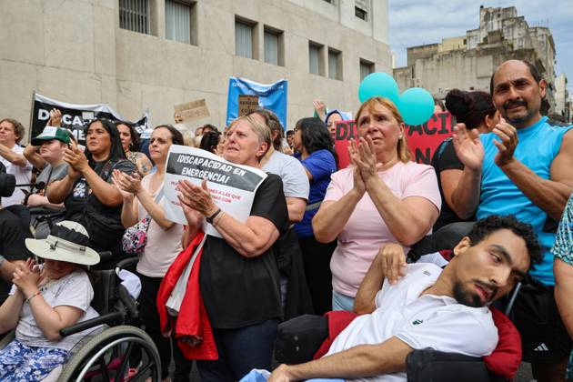 October 22, 2025, Buenos Aires, Buenos Aires, Argentina: Relatives of people with disabilities applaud a speech near the National Ministry of Health during a demonstration urging the executive branch to enforce the Disability Emergency Law. Buenos Aires Argentina - ZUMAp265 20251022_zip_p265_008 Copyright: xDelfinaxCorberaxPix