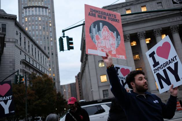 October 22, 2025, New York, New York, USA: A protester holds signs saying Ã¢â‚¬oeImmigrants are New YorkÃ¢â‚¬Â and Ã¢â‚¬oeI Love Immigrant NYÃ¢â‚¬Â during a demonstration at Foley Square, in New York, on Wednesday, Oct. 22, 2025. This response comes after more than 50 federal agents arrested immigrant vendors at Canal Street, lower Manhattan, on Tuesday. New York USA - ZUMAs368 20251022_zip_s368_017 Copyright: xMarcoxPostigoxStorelx