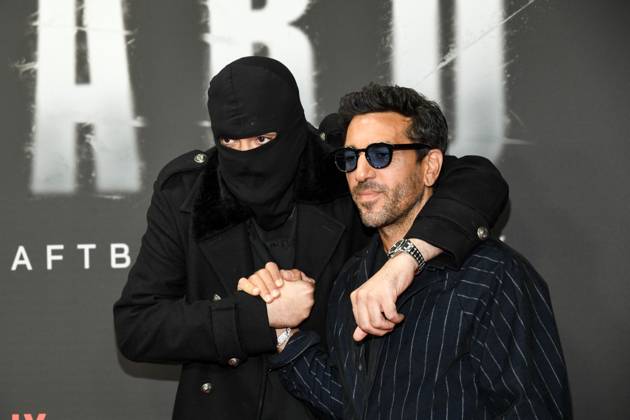 abb Haftbefehl Aykut Anhan with balaclava and Elyas M Barek as guests on the red carpet of the special screening event of the Netflix documentary highlight Babo The Haftbefehl Story at the Astor Film Lounge on 24 10 2025in Berlin Berlin Germany