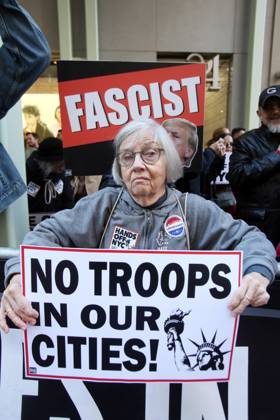 October 25, 2025, New York City, New York, USA: A woman holds a sign that says No Troops in our Cities during a Hands Off NYC rally. outside of Trump Tower. Some women wore polka dots in honor of a protestor who confronted ICE agents and tank vehicles. The peaceful rally drew a handful of Trump supporters. New York City USA - ZUMAk45_ 20251025_zaf_k45_009 Copyright: xKristaxKennellx