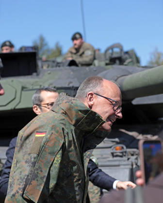 Federal Chancellor Friedrich Merz at the Bundeswehr in Munster He lowers his head in front of a Leopard 2 tank barrel on edge Federal Chancellor Friedrich Merz at the Bundeswehr in Munster He lowers his head in front of a Leopard 2 tank barrel Munster Lower Saxony Germany