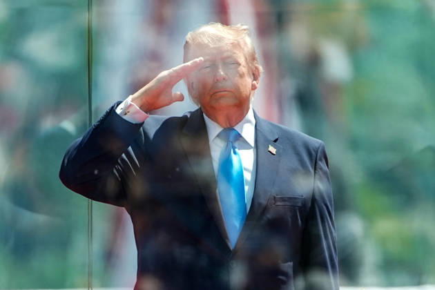 President Donald Trump salutes during the National Anthem before delivering the commencement address at the United States Coast Guard Academy s graduation ceremony in New London, Connecticut on Wednesday, May 20, 2026. CONN20260520435 ANGELINAxKATSANIS
