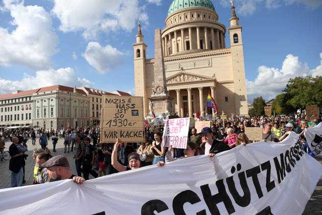 Protesters carrying a banner reading Review today, ban tomorrow march around the state parliament during a demonstration calling for the Federal Constitutional Court to review far-right parties, Alter Markt, Potsdam, September 12, 2026. Review demonstration in Potsdam