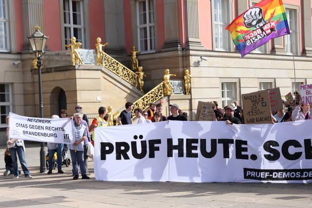 Protesters carrying a banner reading Review Today, Schütz Tomorrow march around the state parliament during a demonstration calling for the Federal Constitutional Court to review far-right parties, Alter Markt, Potsdam, September 12, 2026. Review demonstration in Potsdam