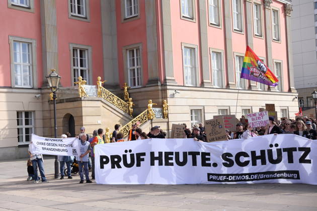 Protesters carrying a banner reading Review Today, Schütz Tomorrow march around the state parliament during a demonstration calling for the Federal Constitutional Court to review far-right parties, Alter Markt, Potsdam, September 12, 2026. Review demonstration in Potsdam