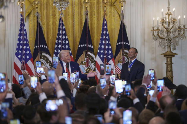 October 6, 2026, Washington, Dc, United States of America: Guests take photos using their phones as U.S. President Donald Trump and golfer Tiger Woods appear at a reception honoring Black History Month in the East Room of the White House, February 20, 2025 in Washington, D.C. Trump introduced golfer Tiger Woods as a surprise guest at the reception in the East Room, where he praised Woods as one of the greatest athletes of all time. Washington United States of America - ZUMAp138 20261006_zaa_p138_008 Copyright: xJoycexBoghosian WhitexHousex
