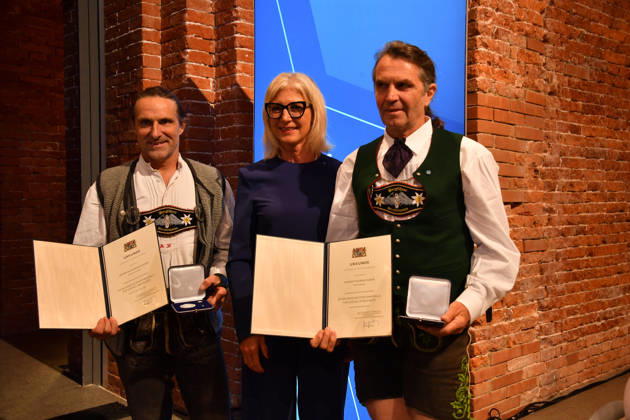 Ulrike Scharf, Bavarian Minister of State, and Alexander and Thomas Huber of Huber Baum; Awarding of the Bavarian State Medal for Social Service 2026; All Saints Day; Hofkirche, Munich; October 6, 2026