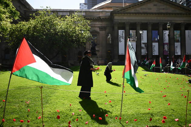 PRO-PALESTINE VIGIL, Pro-Palestine protestors places poppies on the lawn during a vigil for Gaza at the State Library Victoria in Melbourne, Wednesday, October 7, 2026. ( NO ARCHIVING MELBOURNE VICTORIA Australia Copyright: xJOELxCARRETTx 20261007151102079377