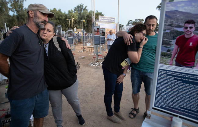 Israelis mourn at sunrise in the Re im memorial on the third anniversary where Hamas massacred 364 people and took another 40 hostages during the Nova dance party on October 7, 2023, near Kibbutz Re im, southern Israel on Wednesday, October 7, 2026. The Hamas cross-border attacks resulted in the deaths of approximately 1,200 people and the abduction of 251 hostages. ISR202606080026 JimxHollander