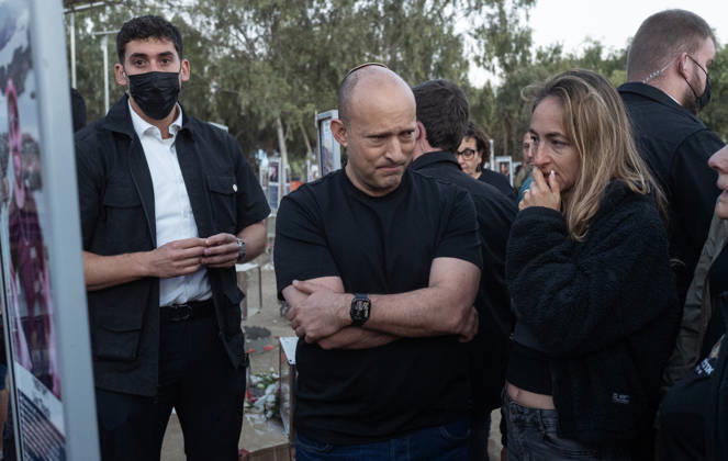 Former Prime Minister and currently running in the upcoming October 27 Israeli elections, Naftali Bennet stops and listens to a relative of one the Israelis murdered by Hamas on October 7, 2023, as Israelis flock at sunrise in the Re im memorial on the third anniversary of the Hamas attack on Israel where massacred 364 people here were murdered and another 40 were taken hostage, near Kibbutz Re im, southern Israel on Wednesday, October 7, 2026.  ISR202606080023 JimxHollander
