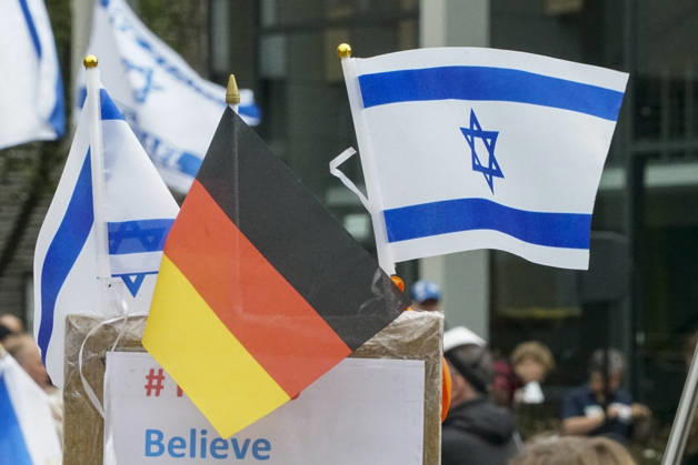 CNTV VIGIL: Demonstrators on the street; participants holding German and Israeli flags at the vigil marking the third anniversary of the attack and massacre in Israel; people gathering in front of the Audimax in the Grindelviertel neighborhood of Hamburg on October 7, 2026, Hamburg, Germany