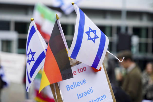 CNTV VIGIL: Demonstrators on the street; participants holding German and Israeli flags at the vigil marking the third anniversary of the attack and massacre in Israel; people gathering in front of the Audimax in the Grindelviertel neighborhood of Hamburg on October 7, 2026, Hamburg, Germany