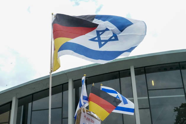 CNTV VIGIL: Demonstrators on the street; participants holding German and Israeli flags at the vigil marking the third anniversary of the attack and massacre in Israel; people gathering in front of the Audimax in the Grindelviertel neighborhood of Hamburg on October 7, 2026, Hamburg, Germany