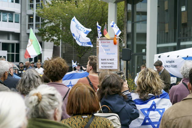 CNTV VIGIL: Demonstrators on the street; participants holding German and Israeli flags at the vigil marking the third anniversary of the attack and massacre in Israel; people gathering in front of the Audimax in the Grindelviertel neighborhood of Hamburg on October 7, 2026, Hamburg, Germany
