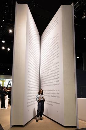 78th Frankfurt Book Fair: A visitor to the Frankfurt Book Fair reads a book inside a giant model of a book. The 78th Frankfurt Book Fair will take place October 7–11, 2026, at the Frankfurt am Main Exhibition Center in Hesse, Germany. 2026-10-07_frankfurter-buchmesse_16