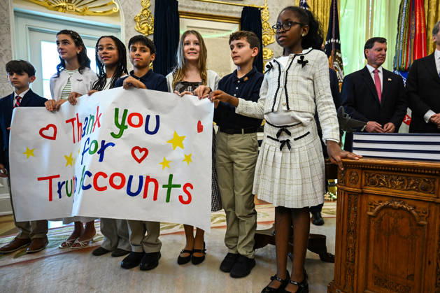 Trump Makes Oval Office Announcement WASHINGTON, DC - OCT. 7: Kids hold up a sign as US President Donald Trump speaks during an announcement on Trump Accounts in the Oval Office on Wednesday, Oct. 7, 2026 at the White House in Washington, D.C. (Photo by Annabelle Gordon Pool For The Washington Post) Washington DC United States Copyright: xPool ABACAx