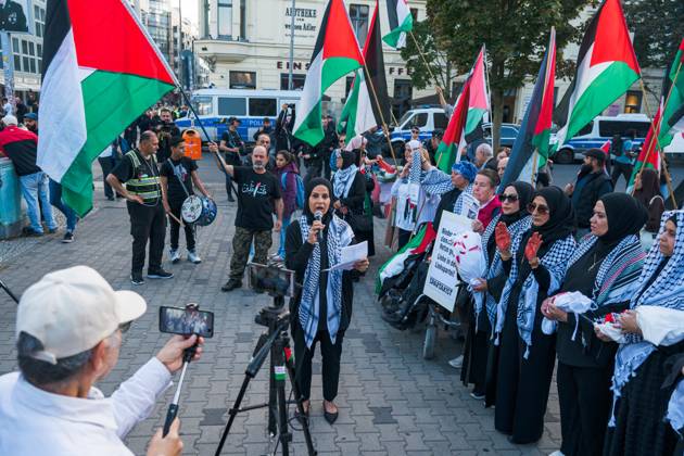 October 7, 2026, Berlin, Berlin, Germany: BERLIN, GERMANY, OCTOBER 7, 2026: Demonstrators gather at Checkpoint Charlie in central Berlin to mark three years since the start of the Gaza war. Participants protest against Israelâ€⠢s military actions in Gaza, which they describe as genocide, and express solidarity with Palestinians. Berlin Germany - ZUMAq101 20261007_zna_q101_408 Copyright: xNikosxKanistrasx