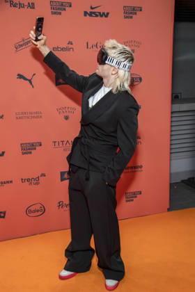 ABB ABOUTYOU Ski Aggu as a guest on the orange carpet at the ABOUT YOU Opera Fashion Show at the Admiralspalast on October 7, 2026, in Berlin, Germany
