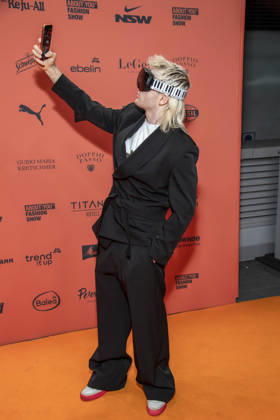 ABB ABOUTYOU Ski Aggu as a guest on the orange carpet at the ABOUT YOU Opera Fashion Show at the Admiralspalast on October 7, 2026, in Berlin, Germany