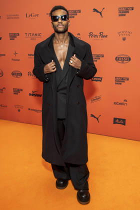 ABB ABOUTYOU Tijan Njie walks the orange carpet at the ABOUT YOU Opera Fashion Show at the Admiralspalast on October 7, 2026, in Berlin, Germany