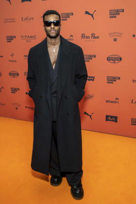 ABB ABOUTYOU Tijan Njie walks the orange carpet at the ABOUT YOU Opera Fashion Show at the Admiralspalast on October 7, 2026, in Berlin, Germany