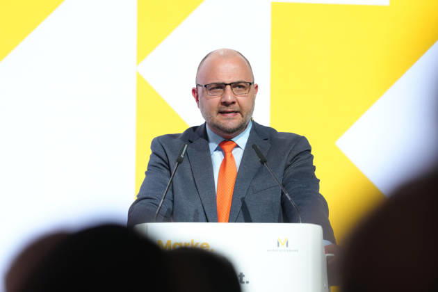 Brand Economy Day 2026: Author and speaker Stefan Kolev on stage during his keynote address at Brand Economy Day 2026, Berlin, October 8, 2026, Berlin, Berlin, Germany